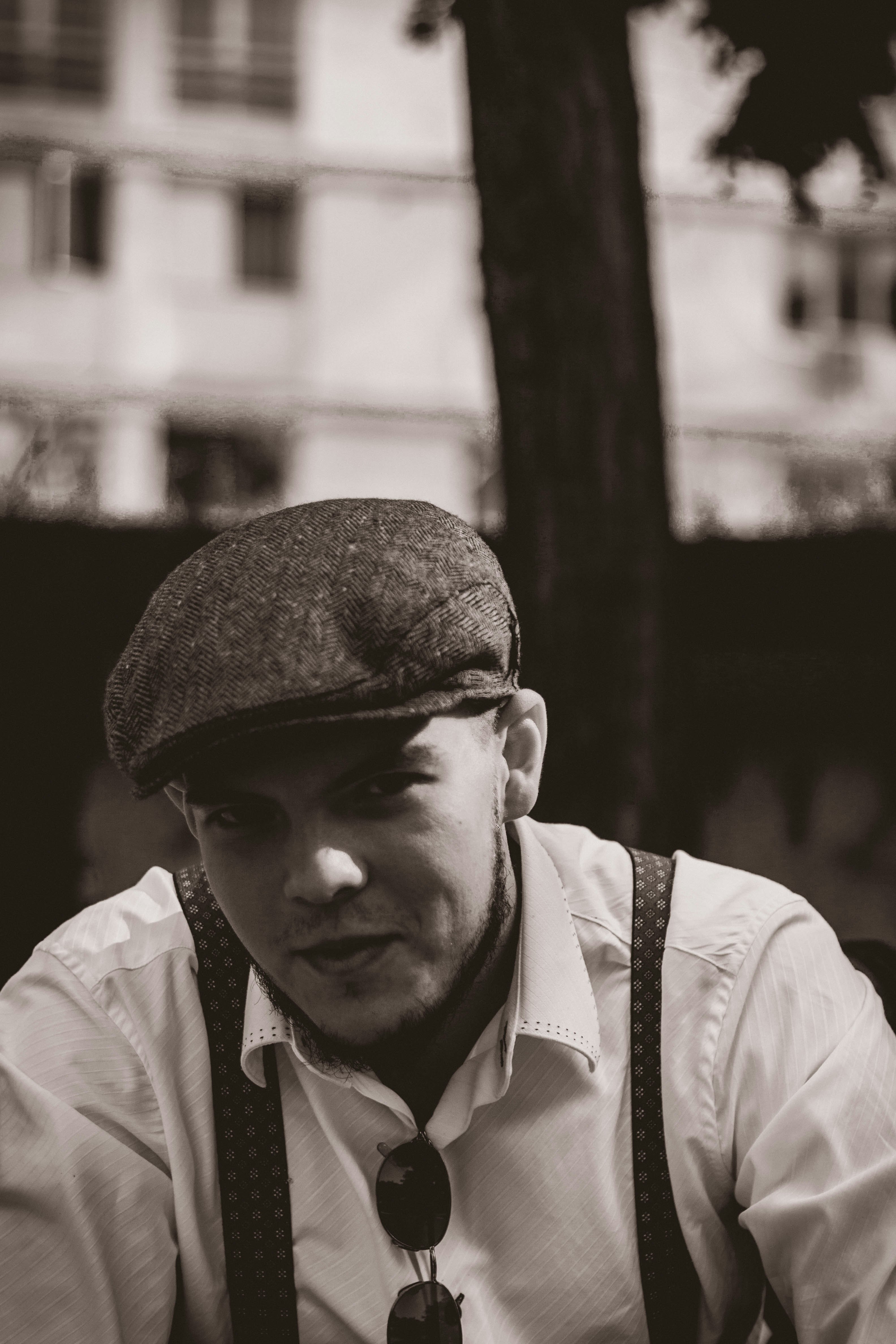 man in white dress shirt and black hat